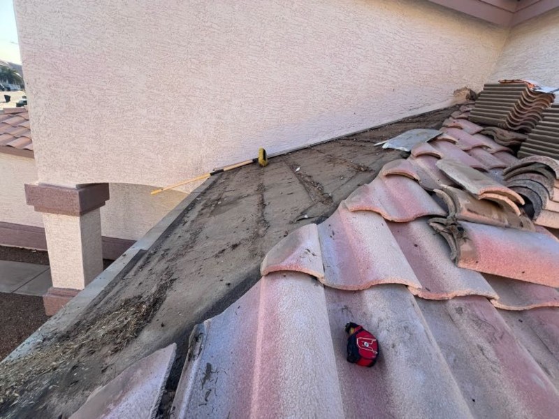 Broken clay tile roof showing monsoon storm damage on a Phoenix home
