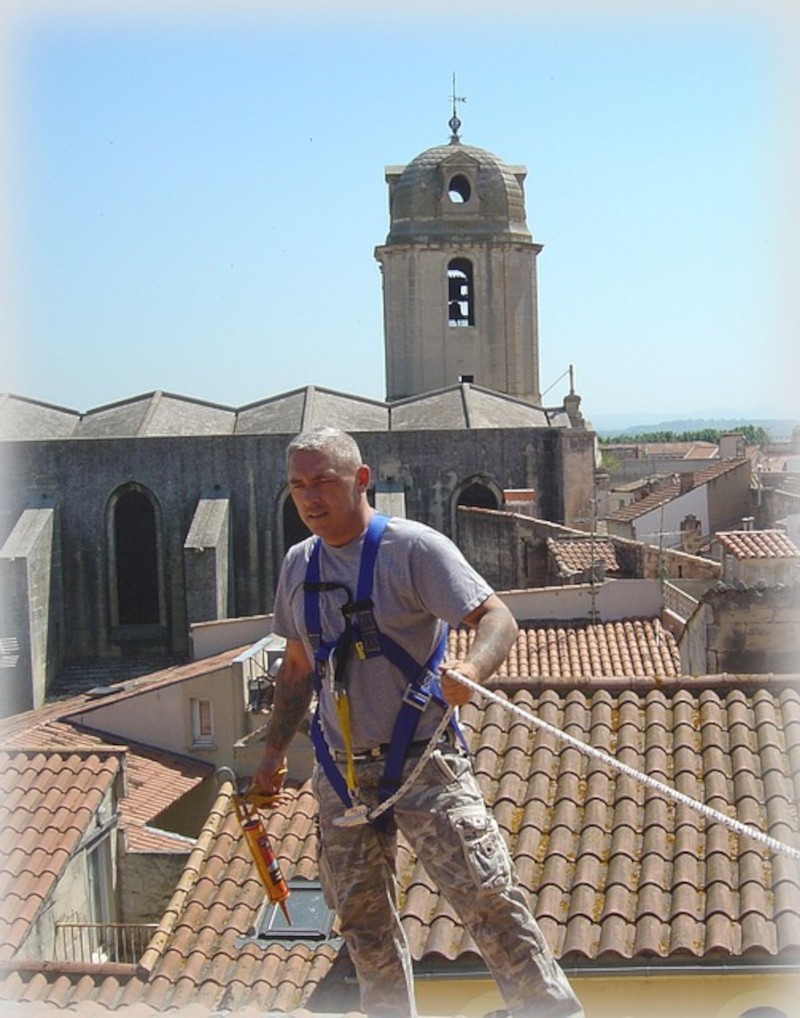 Stradling team member working on a roof